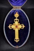 A Victorian unmarked gold crucifix form pendant/brooch Of pierced Gothic Revival design centred