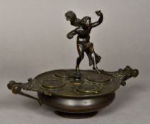 A 19th century Grand Tour bronze inkwell Surmounted with a dancing figure above four lidded wells