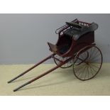 A Victorian dog cart With maroon and black painted decoration and metal spoked wheels. 155 cm long.