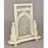 An Indian carved alabaster table screen The central panel extensively carved and pierced,