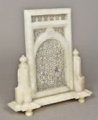 An Indian carved alabaster table screen The central panel extensively carved and pierced,