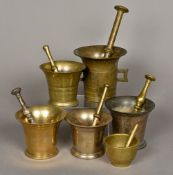 A collection of twelve antique bronze pestles and mortars Each of typical flared form.