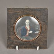 An 18th century portrait miniature of a gentleman wearing a blue coat at his desk Probably on ivory,