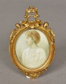 An early 20th century miniature portrait on ivory Depicting a woman wearing a white dress and a