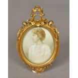 An early 20th century miniature portrait on ivory Depicting a woman wearing a white dress and a