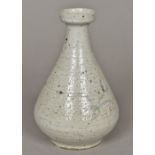 A Japanese or Korean pottery vase Of teardrop form, decorated with foliate sprays on a cream ground.