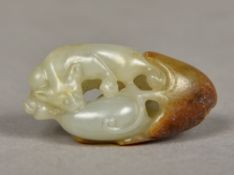 A Chinese carved white and russet jade squirrel and pumpkin pendant 4 cm long.