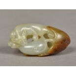 A Chinese carved white and russet jade squirrel and pumpkin pendant 4 cm long.