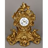 A 19th century French gilt bronze mantel clock The scroll cast case surmounted with two birds above
