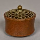 A small Chinese patinated bronze censor Of waisted cylindrical form with a removable pierced lid,