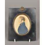 An early 18th century portrait miniature of a gentleman wearing a blue coat In ebonised frame.