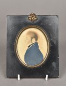 An early 18th century portrait miniature of a gentleman wearing a blue coat In ebonised frame.