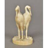 A Japanese carved ivory group Worked as three cranes, standing back to back. 8.5 cm high.