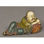 A Chinese carved Shoushon stone Lohan Modelled recumbent with polychrome decoration. 13.5 cm wide.