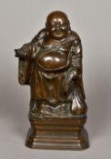 A Chinese bronze Buddha Modelled standing, holding a string of beads and sack of plenty,