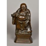 A Chinese bronze Buddha Modelled standing, holding a string of beads and sack of plenty,