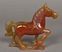 A Chinese carved agate group Worked as a horse with front leg raised. 13.5 cm high.