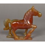 A Chinese carved agate group Worked as a horse with front leg raised. 13.5 cm high.