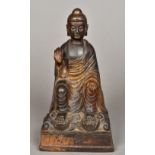 A Chinese lacquered bronze Buddha, possibly 17th century Modelled seat with one hand raised,
