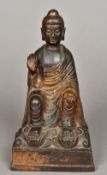 A Chinese lacquered bronze Buddha, possibly 17th century Modelled seat with one hand raised,