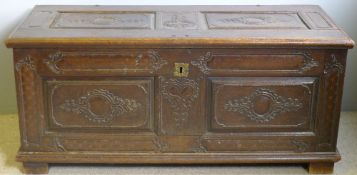 A large 18th century two panel coffer With hinged lid and scroll carved panels,