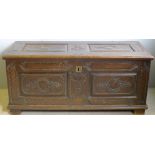 A large 18th century two panel coffer With hinged lid and scroll carved panels,