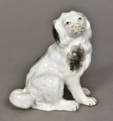 A 19th century porcelain model of a spaniel Naturally modelled seated. 10.5 cm high.