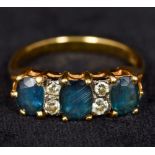 A modern 18 ct gold diamond and sapphire ring Set with three facet cut sapphires interspersed with