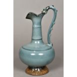 A Chinese porcelain ewer With ribbed neck and spreading lappet moulded foot,