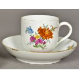 A 19th century Meissen porcelain cup and saucer Painted with floral sprays,