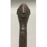 A 19th century African tribal spear, possibly Zulu Carved with a stylised male head. 135 cm long.