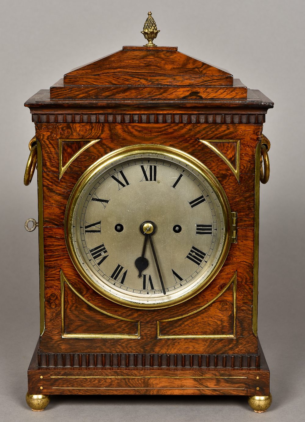 A 19th century brass mounted rosewood bracket clock The stepped domed top surmounted with a