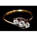 An 18 ct gold three stone diamond crossover ring CONDITION REPORTS: Generally in