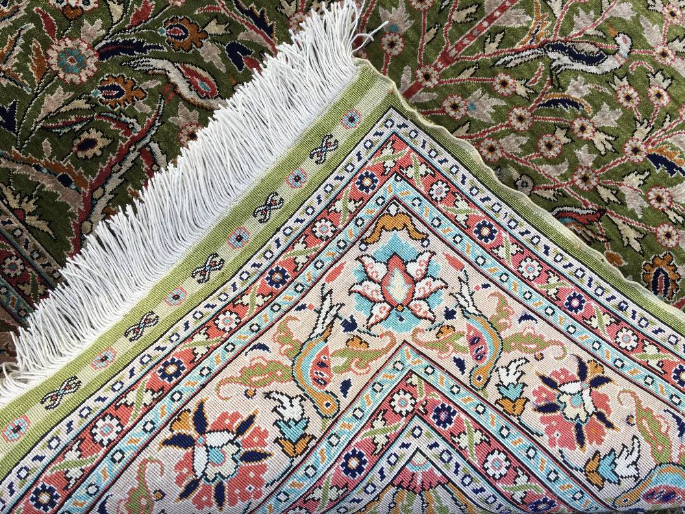 A Turkish silk prayer rug The green mihrab field enclosing a tree of life and exotic birds within - Image 2 of 2