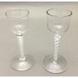 Two Georgian cordial glasses Each with bucket bowl and opaque twist stem. 14.5 cm high.