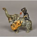 A cold painted bronze group Modelled as a tiger attacking an elephant with a Negro boy on its back.