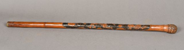 A late 19th century Japanese bamboo walking stick Carved to one side with skeletons and various