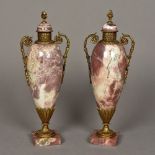 A pair of gilt metal mounted marble urns Each of scrolling twin handled form. Each 40 cm high.