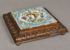An antique Persian pottery tile Centred with the portrait of a gentleman within arabesque spandrels,
