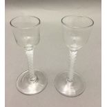Two Georgian cordial glasses Each with bucket bowl and opaque twist stem. 14.5 and 15.5 cm high.
