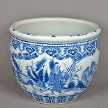 A large Chinese blue and white jardiniere Decorated in the round with figures in various pursuits.