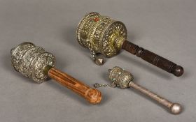 Three Tibetan unmarked white metal mounted prayer wheels Each of typical form, two cabochon mounted.