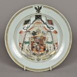 A Chinese Export porcelain armorial plate Centrally polychrome decorated. 23 cm diameter.