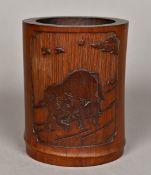 A Chinese carved bamboo brush pot Worked with a buffalo and calf opposing calligraphic script.