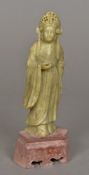 A Chinese carved hardstone figure Modelled standing wearing an elaborate headdress,