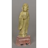 A Chinese carved hardstone figure Modelled standing wearing an elaborate headdress,