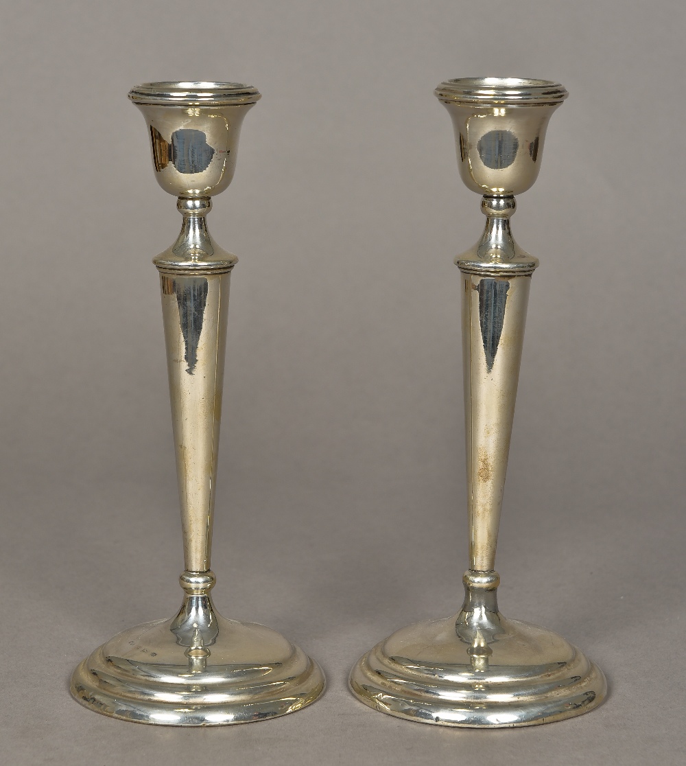 A pair of George V silver candlesticks, hallmarked Birmingham 1911,