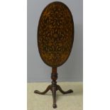 A 19th century Dutch marquetry inlaid tilt-top tripod table The hinged oval top with scrolling