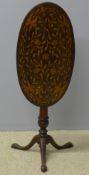 A 19th century Dutch marquetry inlaid tilt-top tripod table The hinged oval top with scrolling