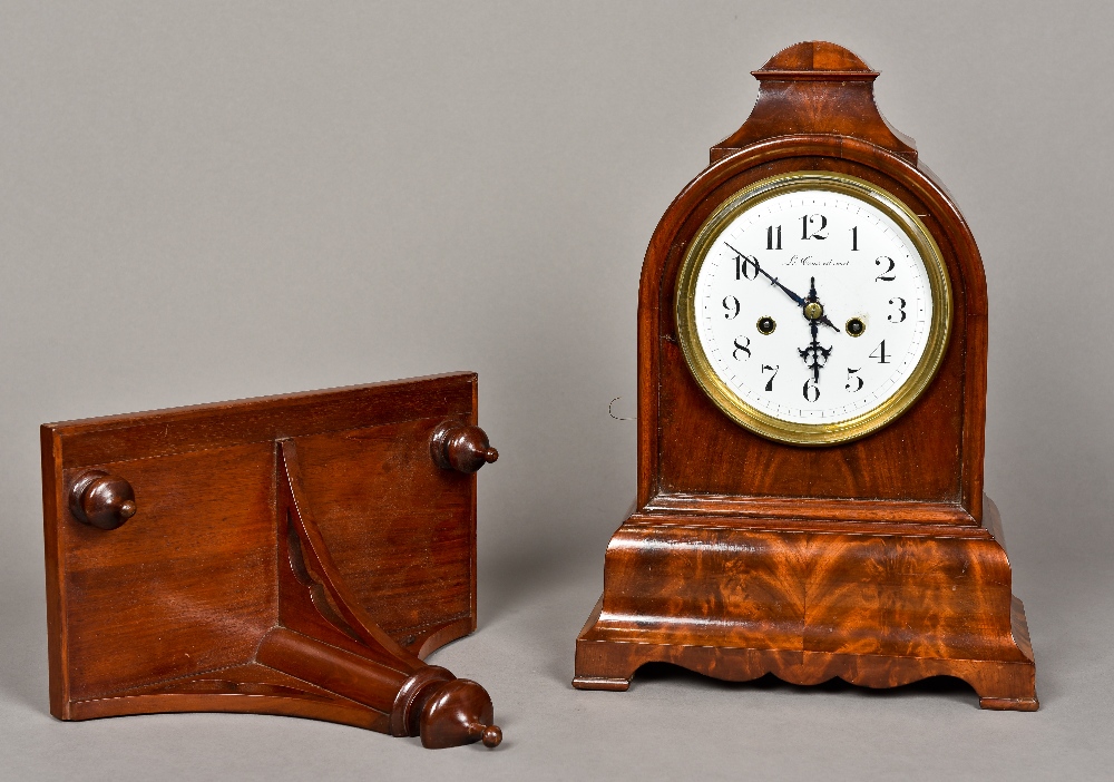 A 19th century mahogany cased bracket clock The arched domed case enclosing the white enamelled